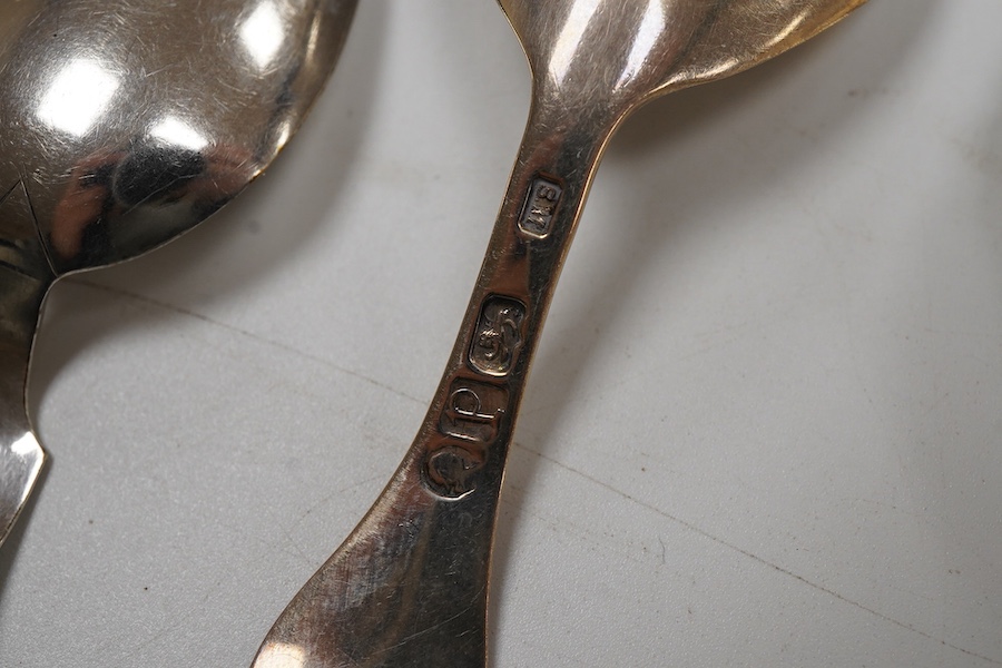A George IV silver fiddle pattern caddy spoon, the bowl engraved with thistles, James Beebe, London, 1825, 90mm, a Georgian siler caddy spoon, the bowl embossed with urn and flowers, a late Victorian silver caddy spoon w